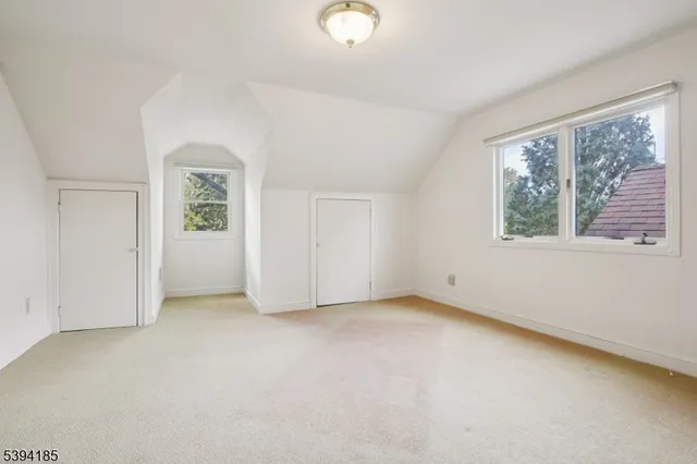 an empty room with windows and closet
