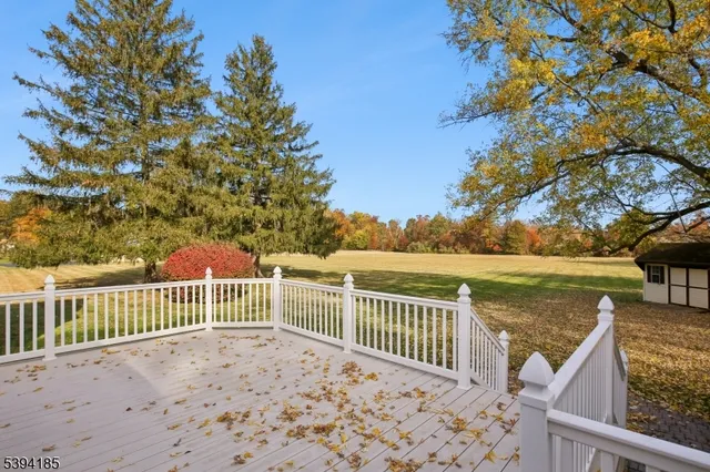 a view of a balcony with wooden floor and fence