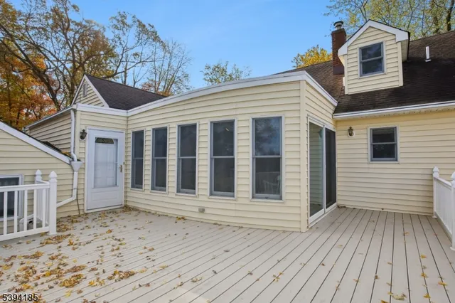 a view of a house with a wooden deck
