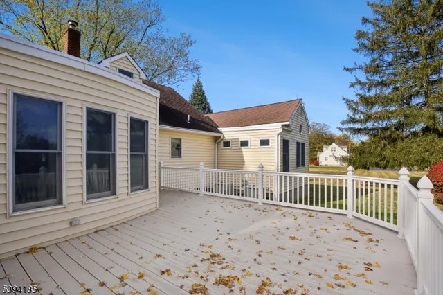 a view of a house with a wooden fence