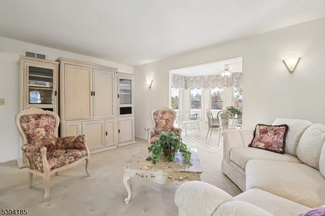 a living room with furniture flowerpot and wooden floor