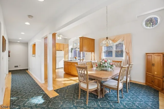 a dining room with furniture and a kitchen view