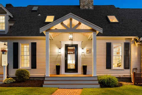 a view of front door of house with a yard