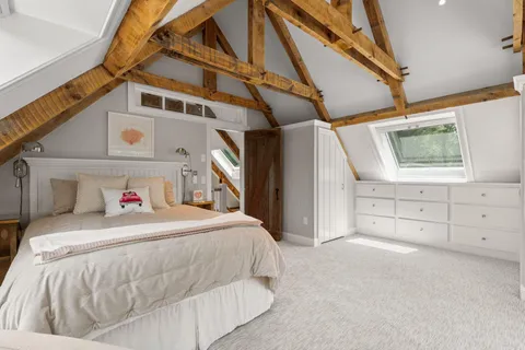 a bedroom with a bed and a staircase