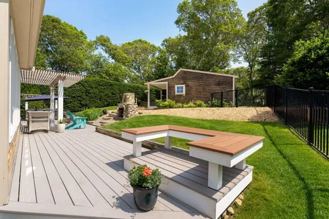 a terrace with outdoor seating and lake view