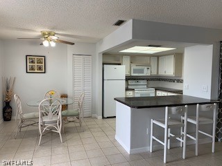 6777 Winkler Road, Unit 273 Fort Myers, FL 33919 - Photo 3 of 32 a kitchen with a dining table and chairs
