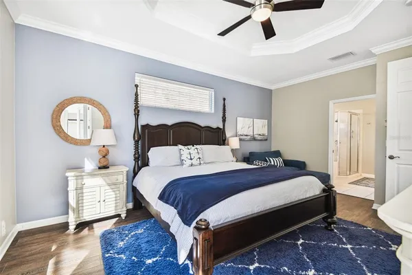 a bedroom with a bed and a flat tv screen on dresser