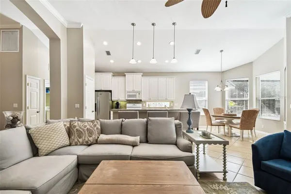 a open kitchen with stainless steel appliances kitchen island granite countertop a sink and a stove top oven with granite countertops