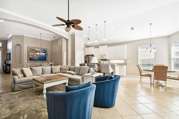 a dining room with furniture a rug and a chandelier