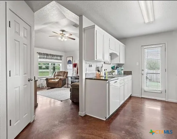 a kitchen with cabinets a sink and appliances