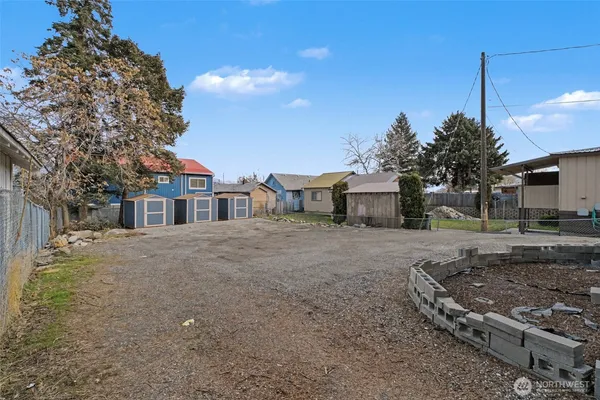 a front view of a house with a garden and tree