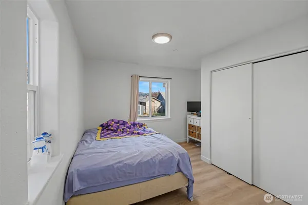 a bedroom with a large bed and a closet