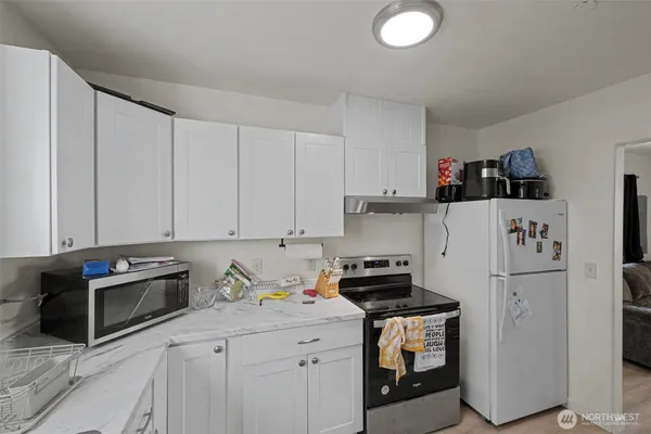 a kitchen with stainless steel appliances granite countertop a refrigerator sink and stove