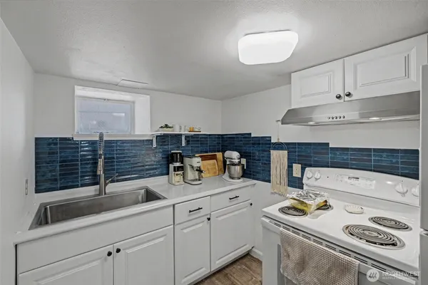 a kitchen with a sink and cabinets