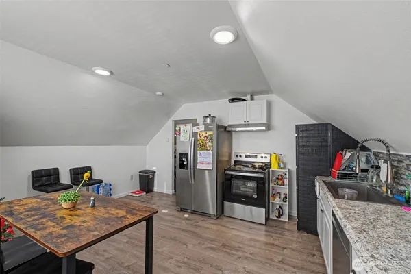 a view of a kitchen with refrigerator and stove