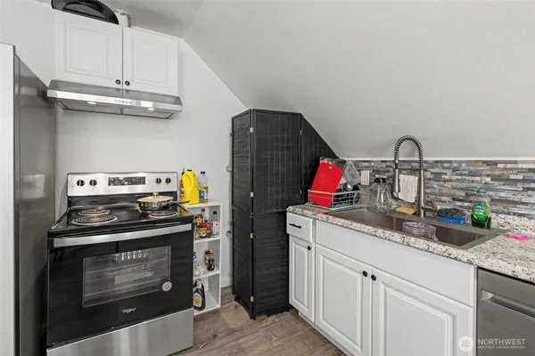 a kitchen with stainless steel appliances granite countertop a stove and a sink