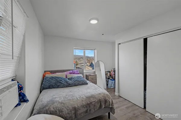 a bedroom with a large bed and a closet