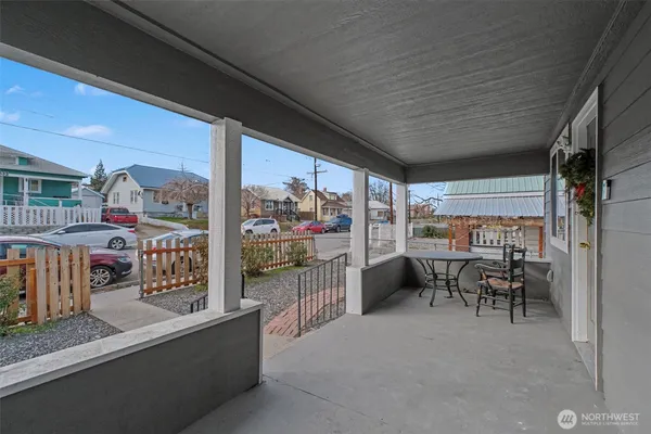 a view of a porch with chairs and table