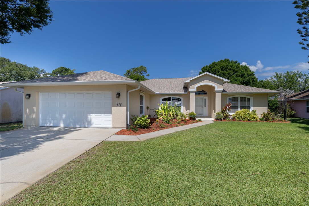 414 Ash Street Sebastian, FL 32958 - Photo 2 of 36 a front view of a house with a yard and garage