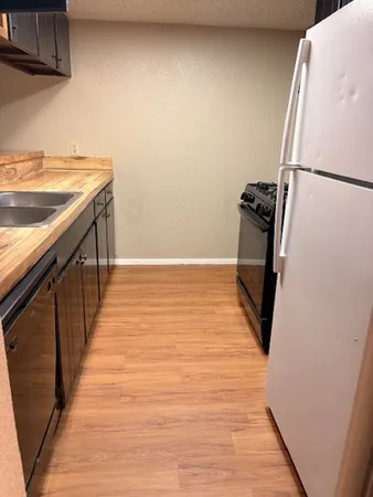 a view of a kitchen with wooden floor