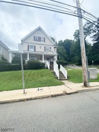a view of a house next to a yard