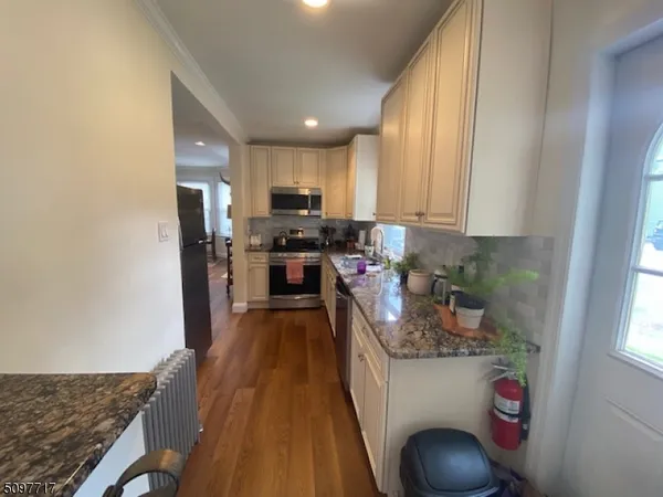 a kitchen with granite countertop lots of counter top space and stainless steel appliances