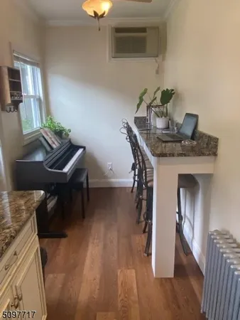 a living room with furniture and a piano
