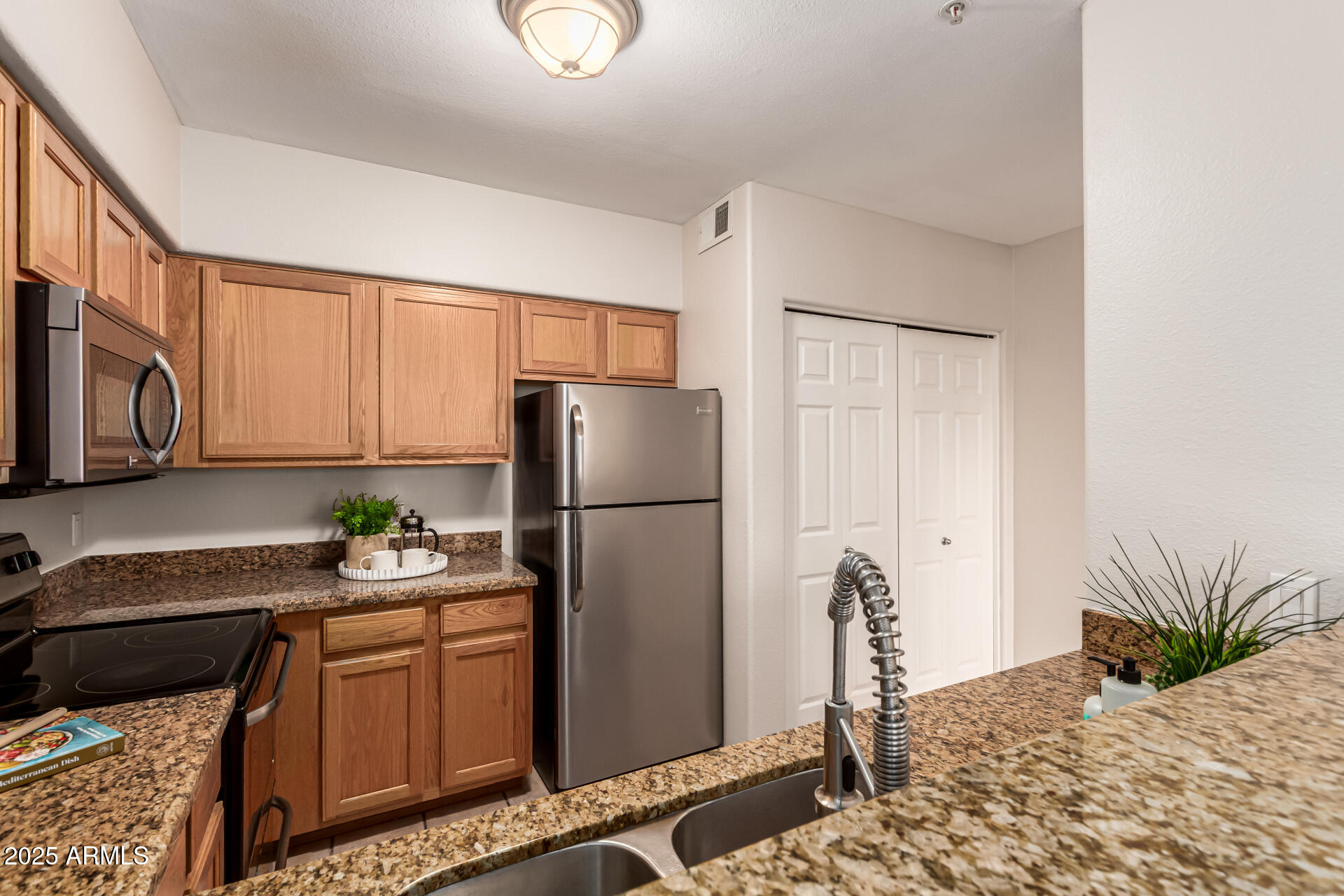 20100 North 78th Place, Unit 1064 Scottsdale, AZ 85255 - Photo 15 of 37 a kitchen with a refrigerator and a sink