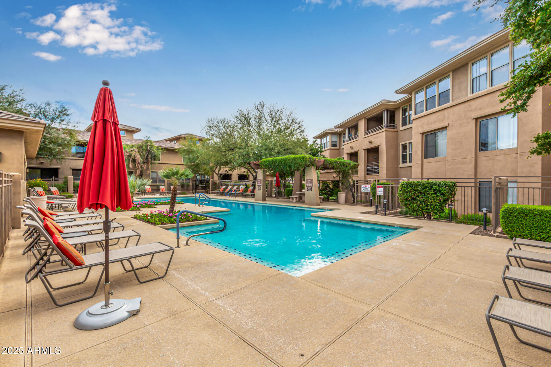 20100 North 78th Place, Unit 1064 Scottsdale, AZ 85255 - Photo 2 of 37 a view of a house with swimming pool and sitting area