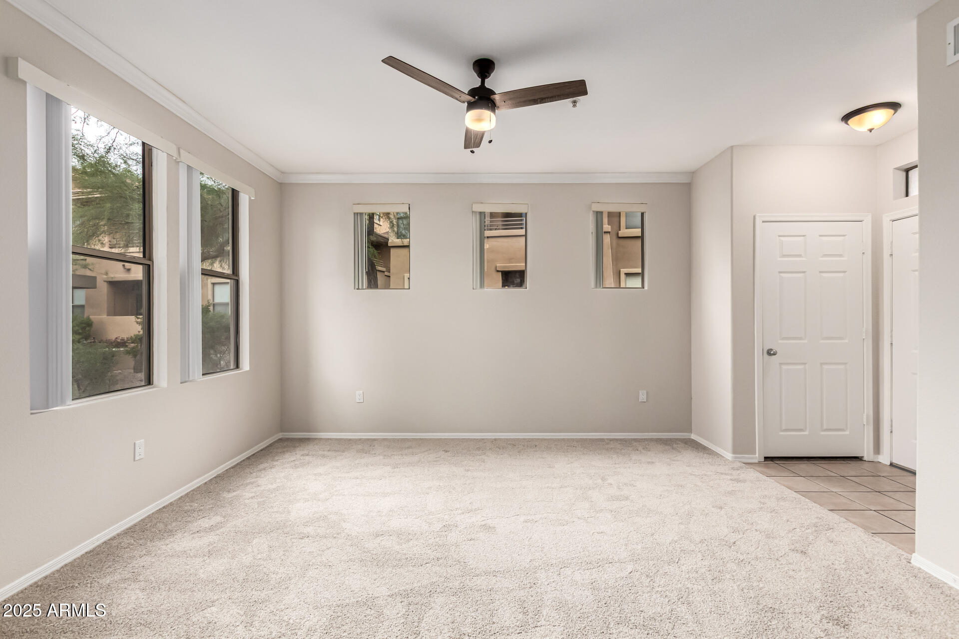 20100 North 78th Place, Unit 1064 Scottsdale, AZ 85255 - Photo 5 of 37 an empty room with windows and ceiling fan