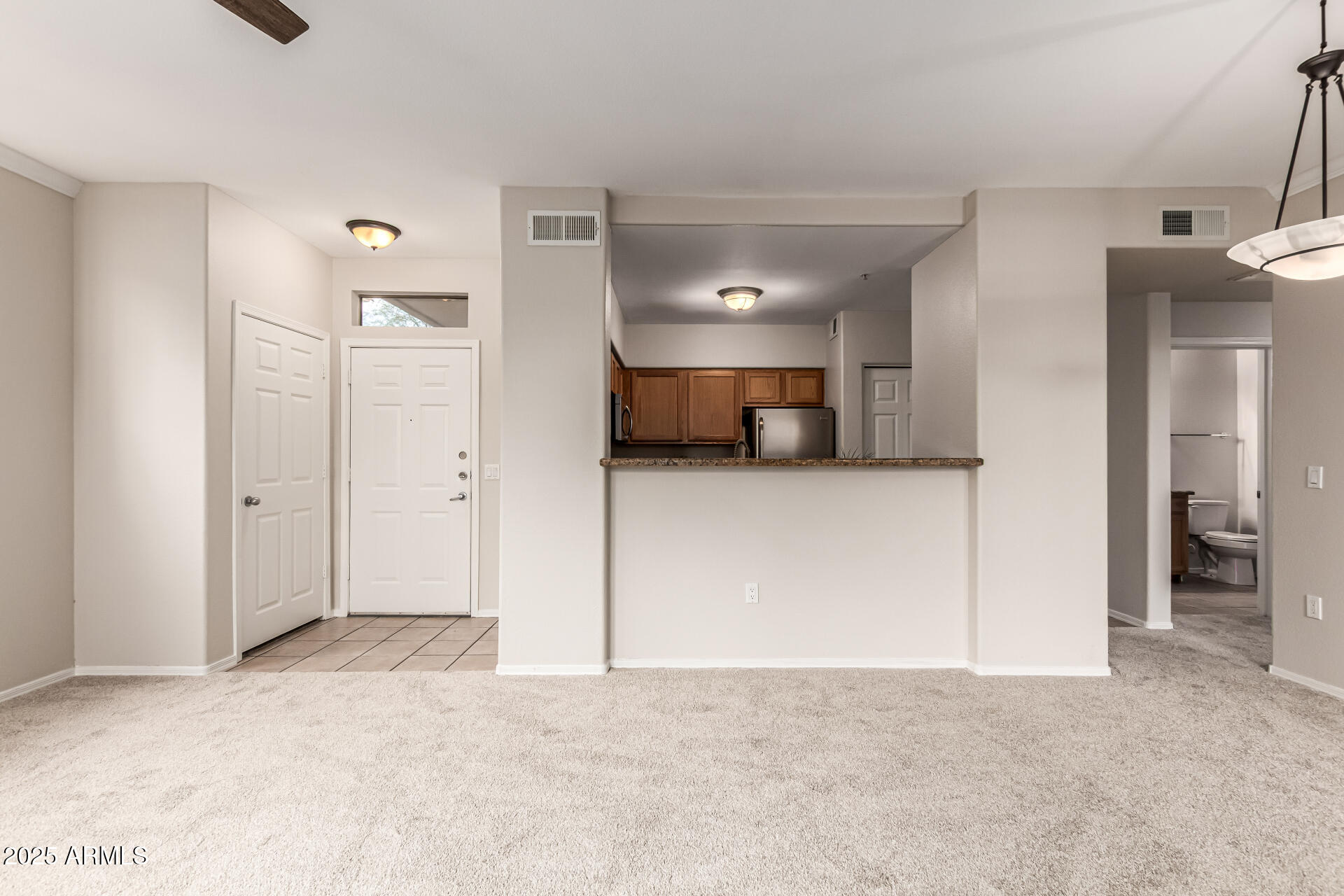 20100 North 78th Place, Unit 1064 Scottsdale, AZ 85255 - Photo 8 of 37 a view of a livingroom and a kitchen