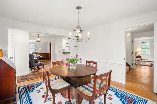 a view of a dining room with furniture wooden floor and chandelier