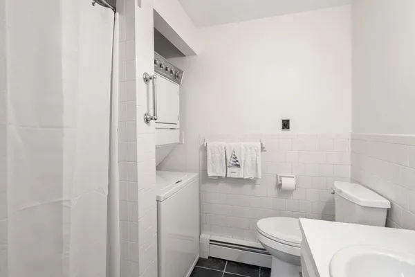 a bathroom with a toilet sink and shower