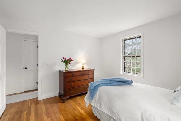 a bedroom with a bed and a window