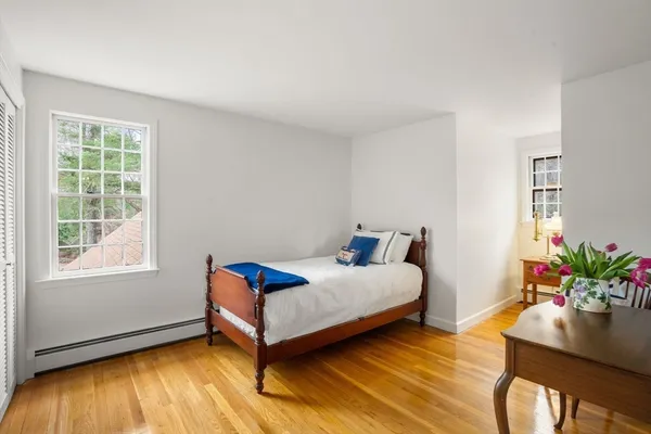 a bedroom with a bed and a potted plant