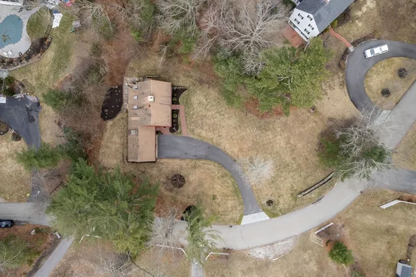 an aerial view of a house with a yard