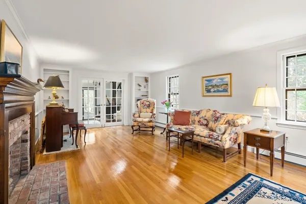 a living room with furniture a fireplace and a window