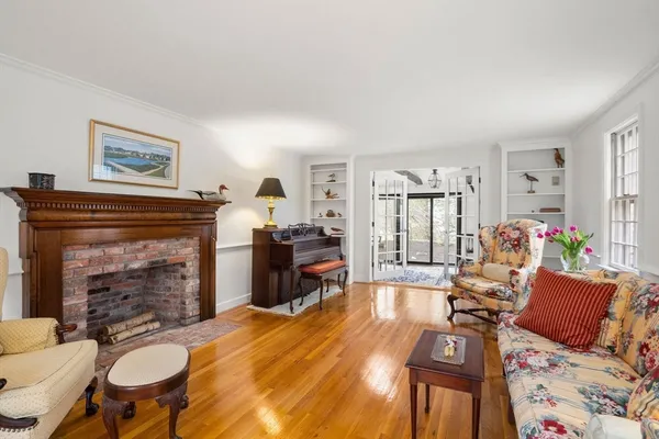 a living room with furniture a fireplace and a table