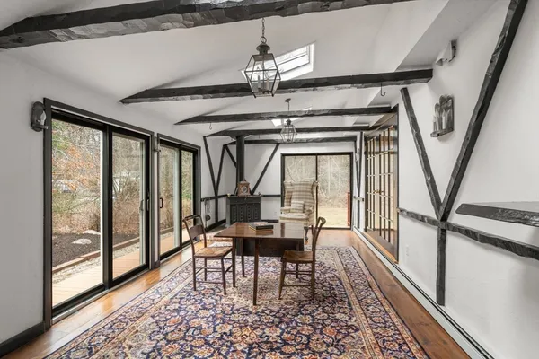 a view of a room with furniture wooden floor and windows