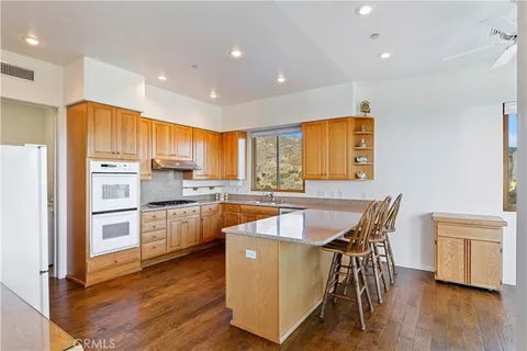 a kitchen with stainless steel appliances a sink stove and cabinets