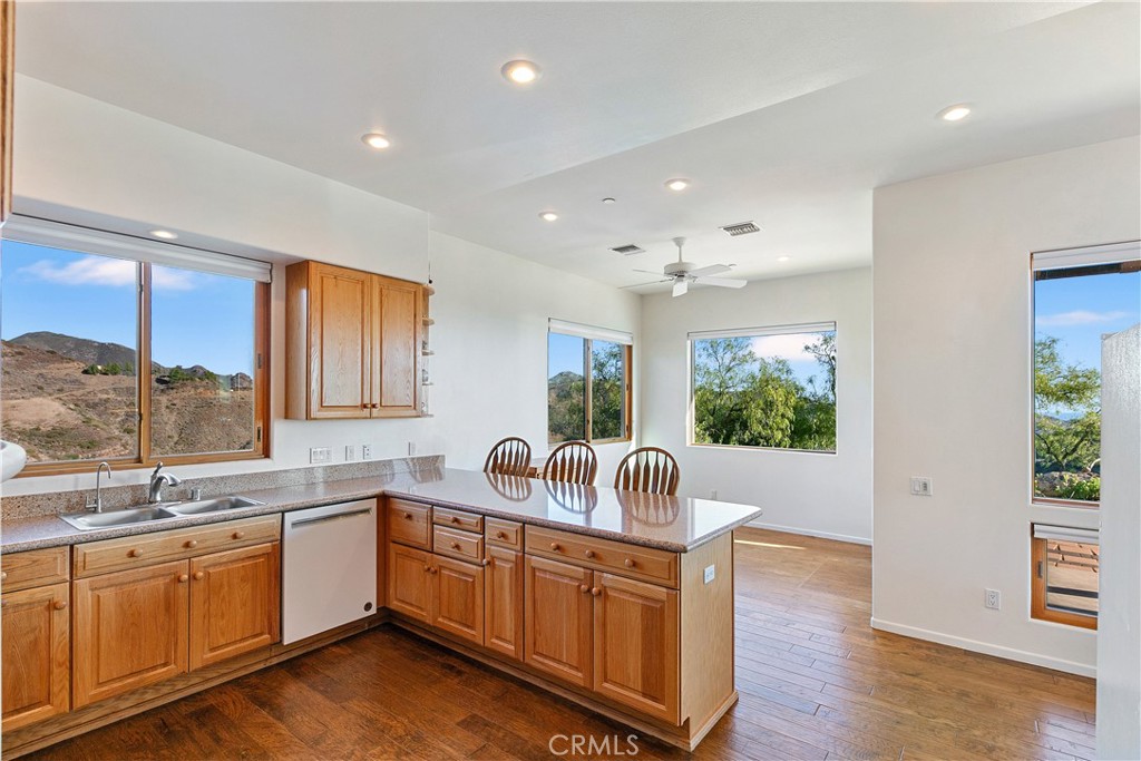 8400 Mipolomol Road Malibu, CA 90265 - Photo 17 of 59 a kitchen with sink a refrigerator and wooden floor