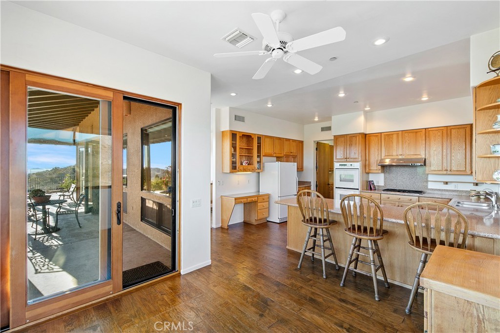 8400 Mipolomol Road Malibu, CA 90265 - Photo 19 of 59 a view of a dining room with furniture window and wooden floor
