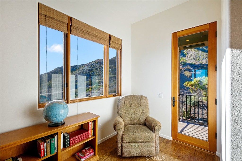 8400 Mipolomol Road Malibu, CA 90265 - Photo 26 of 59 a living room with furniture a rug and a large window