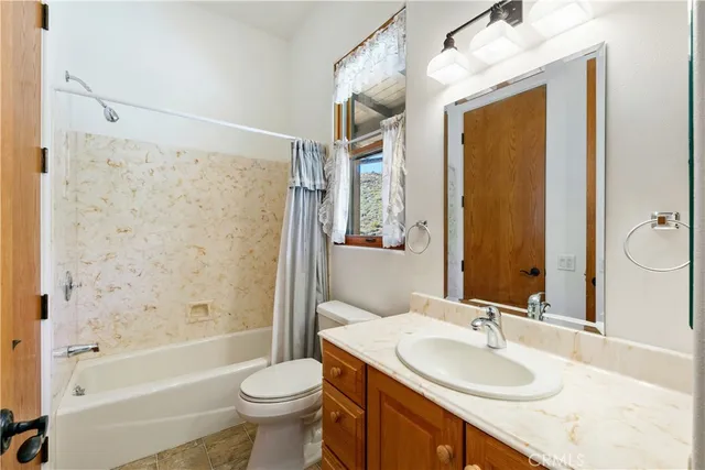 a view of a dining room with furniture and a chandelier