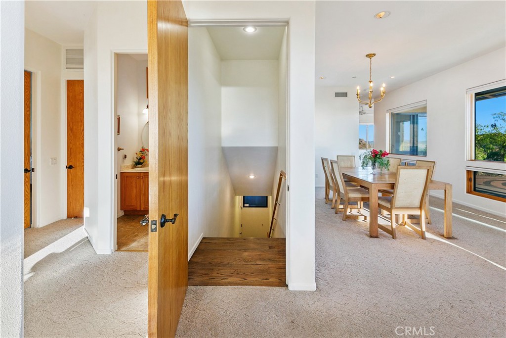 8400 Mipolomol Road Malibu, CA 90265 - Photo 40 of 59 a view of a dining room with furniture and a chandelier