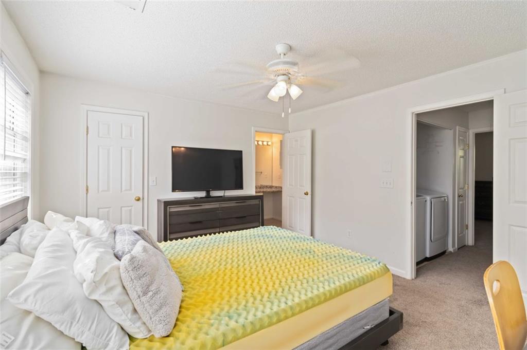 3752 Berkeley Crossing Duluth, GA 30096 - Photo 11 of 23 a bedroom with a bed and a flat screen tv