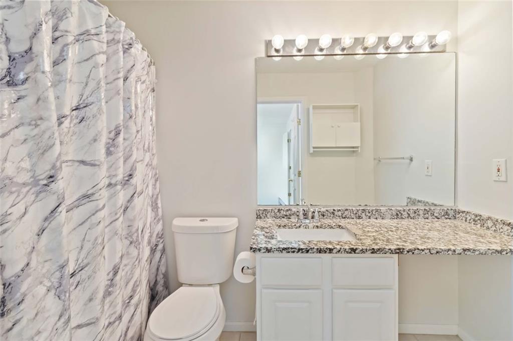 3752 Berkeley Crossing Duluth, GA 30096 - Photo 13 of 23 a bathroom with a granite countertop sink a toilet and a mirror