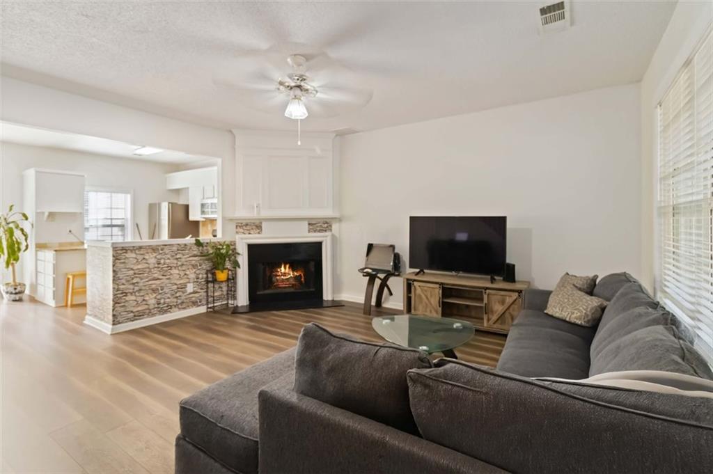 3752 Berkeley Crossing Duluth, GA 30096 - Photo 17 of 23 a living room with furniture a flat screen tv and a fireplace