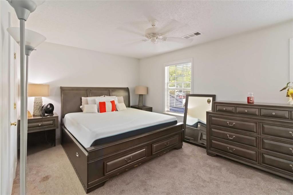 3752 Berkeley Crossing Duluth, GA 30096 - Photo 18 of 23 a bedroom with a bed and a chandelier