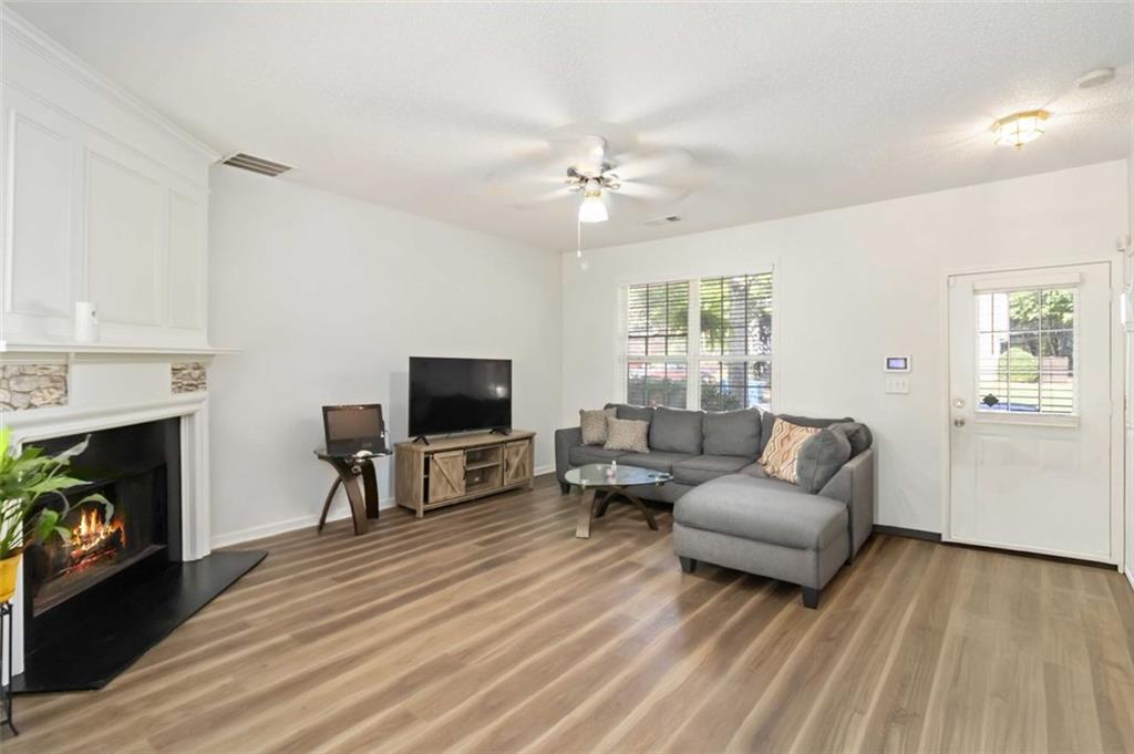 3752 Berkeley Crossing Duluth, GA 30096 - Photo 19 of 23 a living room with furniture a fireplace and a flat screen tv